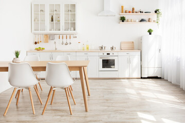 Scandinavian kitchen interior with white furniture and shelves, wooden dining table, empty space