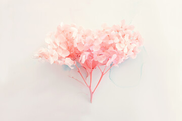Creative image of pastel pink Hydrangea flowers on artistic ink background. Top view with copy space