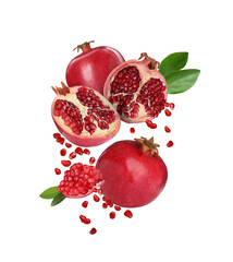 Juicy ripe pomegranates and green leaves flying on white background