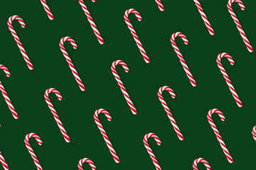 Candy canes isolate on a green background. Pattern