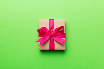 Holiday present box over colored background, top view. Copy space for design