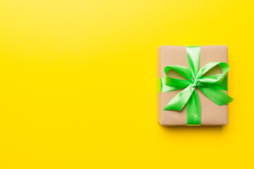 Holiday present box over colored background, top view. Copy space for design