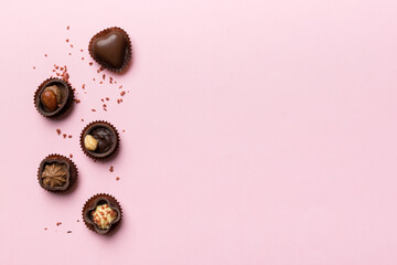 Different kinds of chocolates on colored table close-up. Top View and Flat Lay with copy space