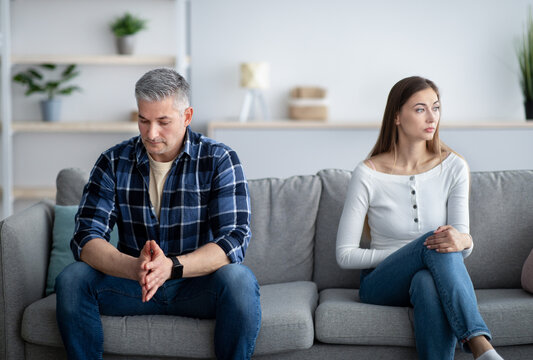 Depressed mature man and woman having relationship problems, going through marital crisis at home