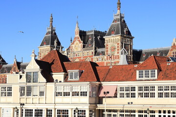 Fototapeta premium Historic Noord-Zuid Hollandsch Koffiehuis Building Exterior Close Up with Amsterdam Central Railway Station in the Background, Netherlands