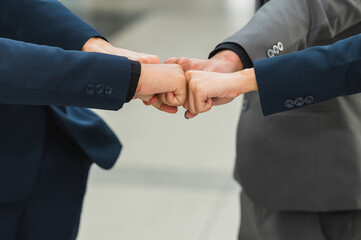 Group of businessmen pushing their fists for business cooperation, concept, business social...