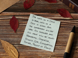 God Jesus Christ birth handwritten Bible verses with red autumn leaves, pen, and old paper on...