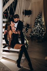 The guy and the girl celebrate Christmas. A loving young married couple on New Year's Eve. Love story.