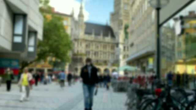 Munich, Germany .Tourists in front of City Hall at Marienplatz square . Mary's public square and New town hall in sunny day. Blurred view. 4K