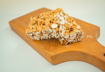 Close up photo of bread and puff rice over the wooden board with white background. That photos is perfect for food pamphlet, product poster, product promotion and ads.