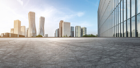Panoramic skyline and modern commercial buildings with empty road