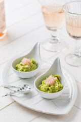 Fresh guacamole with caviar lime (Australian finger lime) fruits and rose sparkling wine