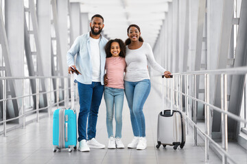 Black family traveling, posing together in airport