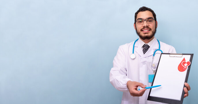 Banner or head web of Arab saudi doctor man posing happy with blood donation form.