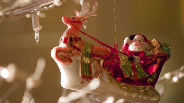 A Christmas ornament gently swaying as it hangs on the tree.