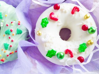 christmas donut box, donuts with icing and sprinkles	