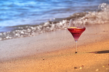 Wine glass with a cocktail by the sea.
