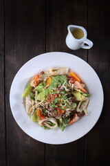 Seafood salad in cheese sauce. Cheese sauce in a saucepan. Flat lay.Top view.Copy space.Menu for a restaurant or cafe. Vertical photo.