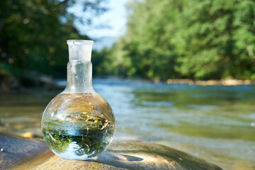 Flask with clear river water.