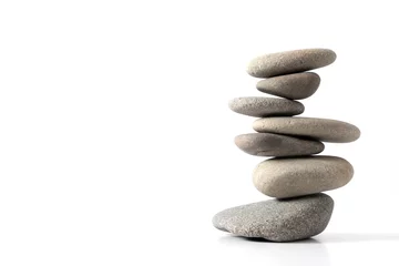 Poster Pyramid of various sea pebbles, pyramid of balanced stones Isolated on white background. Concept harmony, life balance and meditation. © prime1001