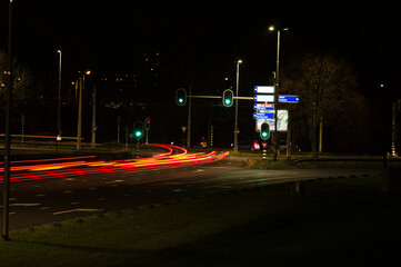 Intersection at night with traffic lights and traffic blurred by motion in Arnhem in the Netherlands