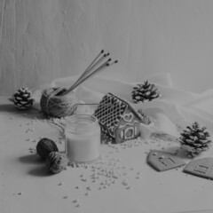 ginger bread house surrounded by many art works placed on snow background for christmas