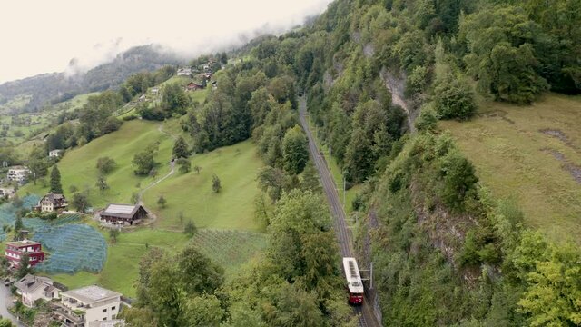 Aerial view on Vitznau municipality (Lucerne, Switzerland) and its main landmark - railway to the Rigi mountain (Rigi Bahnen) in Swiss Alps. 
