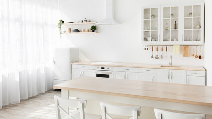 Minimalist light design of kitchen. Dining table with white chairs and utensils on white furniture,...