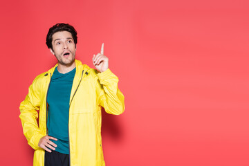 Shocked sportsman in sportswear having idea on red background