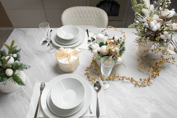 Christmas table with eating utensils. New Year's Eve dinner.