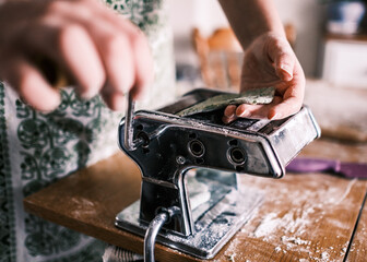 person working pasta machine