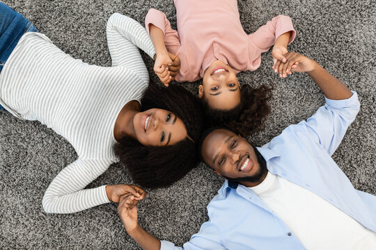 Portrait of african family lying on floor together