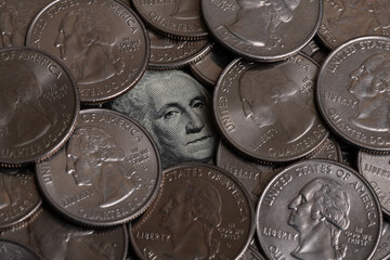 Portrait of George Washington from 1 US dollar banknote surrounded by 25 cent coins