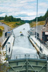 Fototapeta na wymiar Kouvola, Finland - 5 August 2021: Kimola Canal between lakes. Gateway is open for boats going though.
