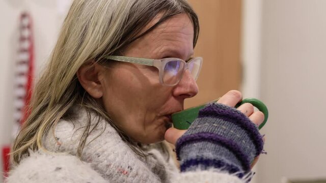 Woman Sipping Tea And Looking At Camera