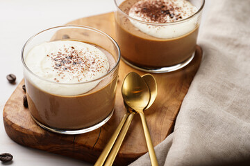 Italian chocolate and coffee mousse dessert semifreddo - half-frozen ice cream with whipped cream and cocoa powder in small glasses