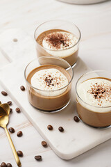 Italian chocolate and coffee mousse dessert semifreddo - half-frozen ice cream with whipped cream and cocoa powder in small glasses