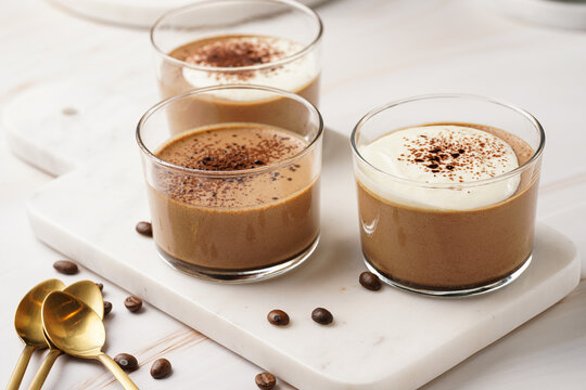 Italian chocolate and coffee mousse dessert semifreddo - half-frozen ice cream with whipped cream and cocoa powder in small glasses