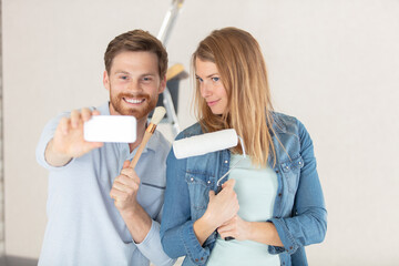 young couple renovating their house taking a selfie