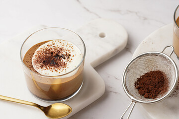 Italian chocolate and coffee mousse dessert semifreddo - half-frozen ice cream with whipped cream and cocoa powder in small glasses