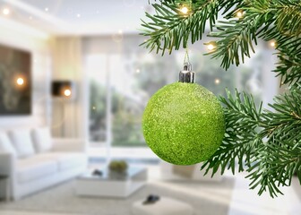 Christmas ball on the Christmas tree surrounded by festive lights.