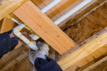 The worker is using a glue PVC pipe for installing the water pipe