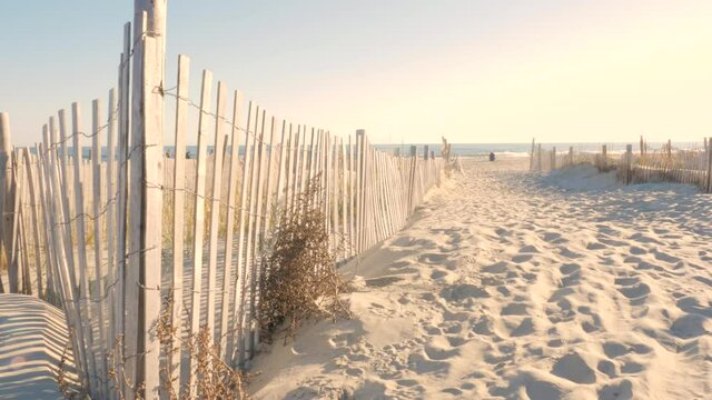 Sand dunes near a beach with fence