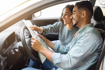 Happy arab man and woman having car trip together