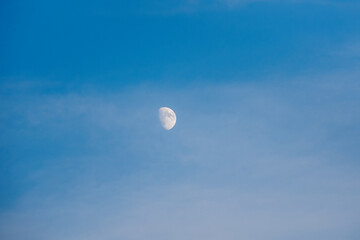 White moon in the evening blue sky. Copy space.