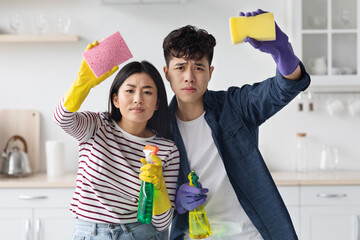 Hard-working asian man and woman house-keeping at kitchen