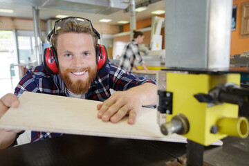 happy carpenter is enjoying his work