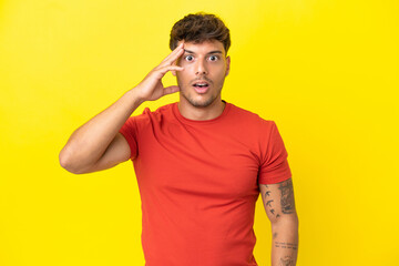 Young caucasian handsome man isolated on yellow background has realized something and intending the solution