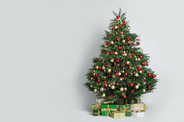 Beautiful Christmas tree with gift boxes on white background