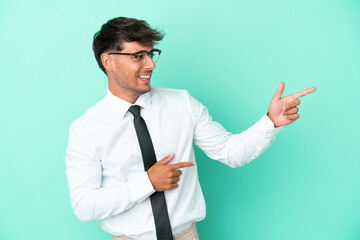 Business caucasian man isolated on blue background pointing finger to the side and presenting a...